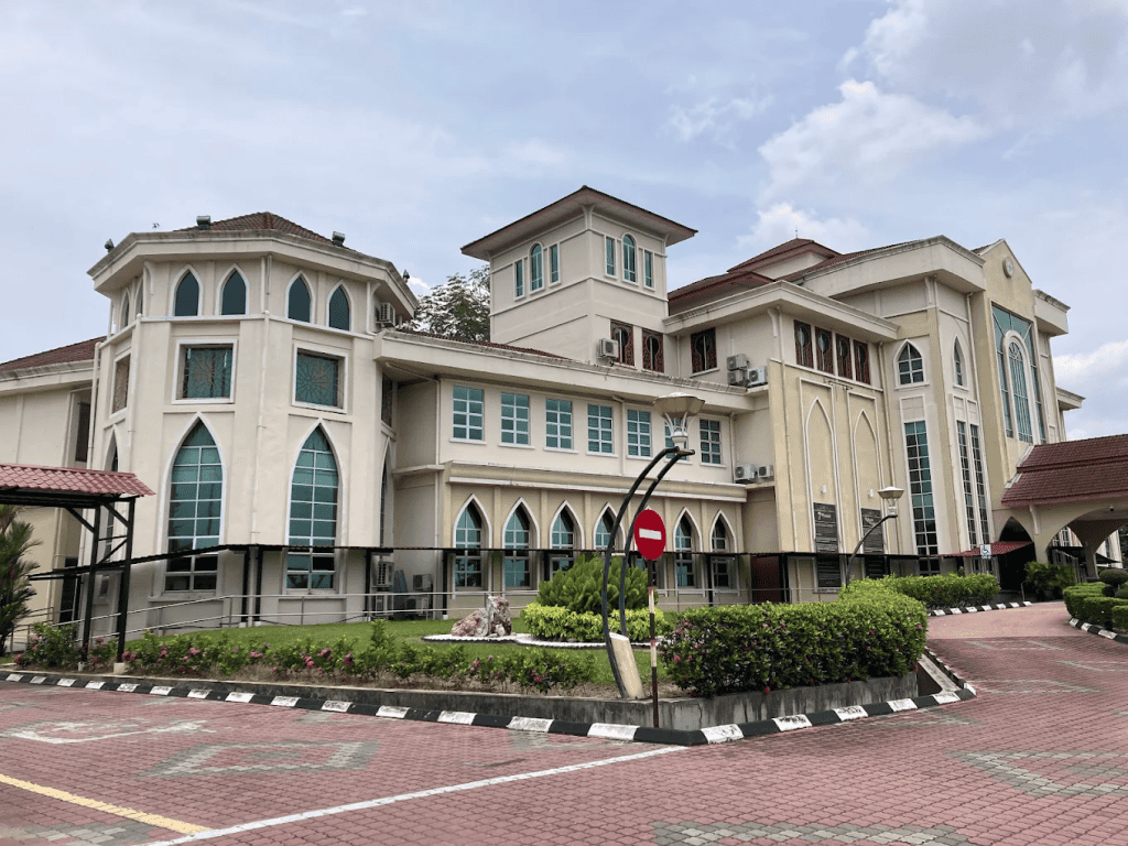 Modern university building with Gothic-style windows and a well-maintained exterior, representing the myPATIL Portal for educational management and student services.