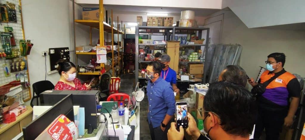 MyPATIL portal staff attending to customers in a hardware store with shelves stocked with tools and supplies, demonstrating the ease of access and service efficiency of the myPATIL portal for online platform management.